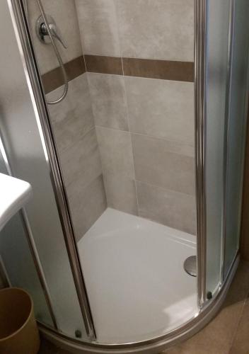 a shower with a glass door in a bathroom at Hotel Caravelle in Riccione