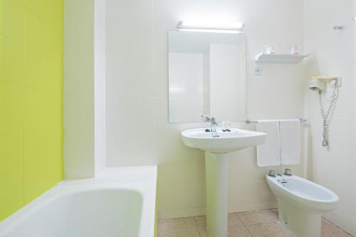 a white bathroom with a sink and a toilet at azuLine Hoteles Mar Amantis & II in San Antonio Bay