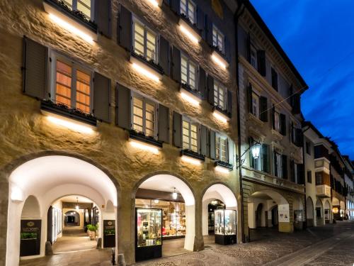a building with arches and lights on a street at Guesthouse Suiteseven in Merano