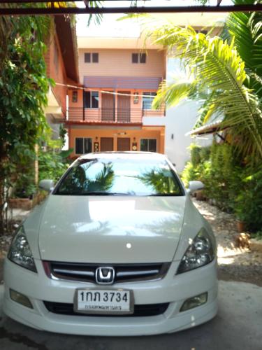 a silver car parked in front of a house at Chom Chan Guesthouse & Hostel in Chiang Mai