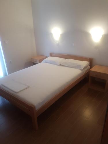 a bed in a room with two lights on top at Apartments Zova in Medulin