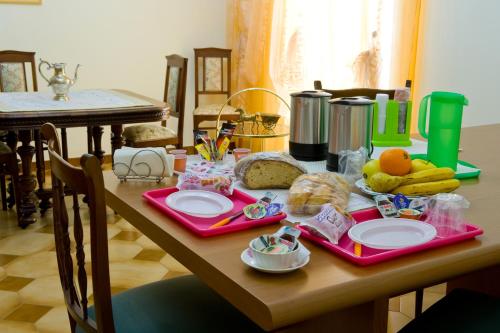 a table with food on it with plates and fruit at B&B Nova Siri in Nova Siri Marina
