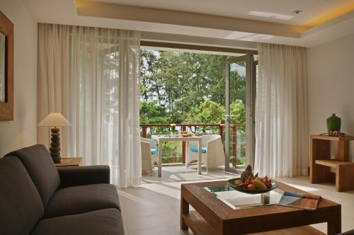 a living room with a couch and a table at Pearl of Naithon in Nai Thon Beach