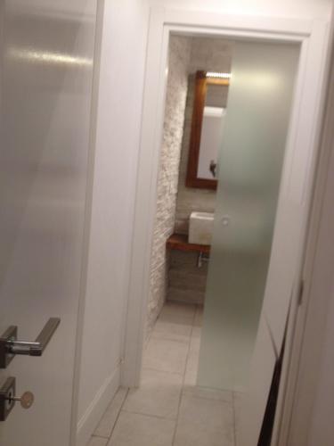 a bathroom with a door leading into a bathroom with a sink at Domus Antiqua San Lorenzo in Genova