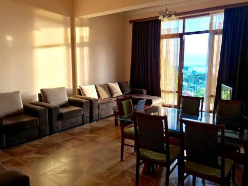 a living room with a couch and a table at 15 Kviparosi Guest House in Makhinjauri