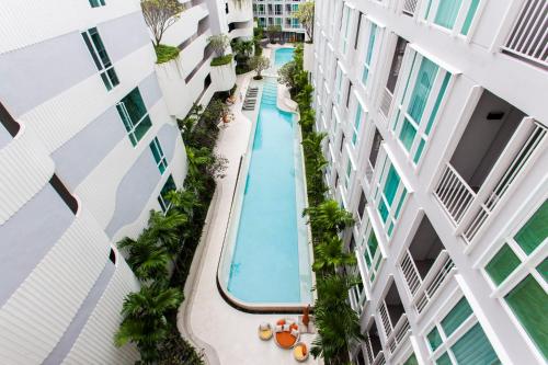 an overhead view of a swimming pool in a building at Phuket Town 1 Bedroom Condo Luxury Facilities, The Base Downtown in Phuket Town