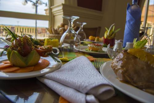 a table with plates of food on top of it at Helnan Auberge Fayoum in Fayoum Center
