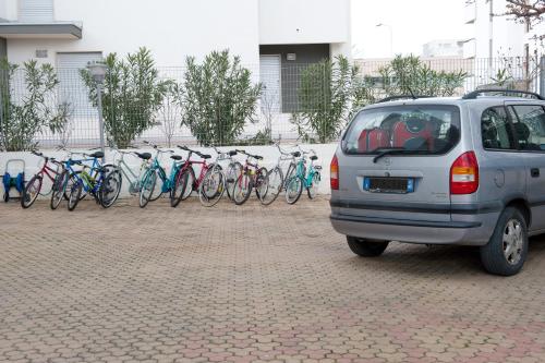 a row of bikes parked in a parking lot at B&B Nova Siri in Nova Siri Marina