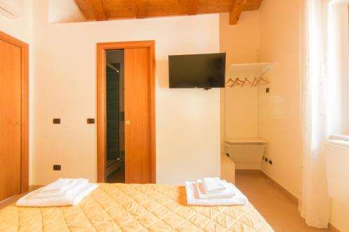 a bedroom with a bed with two towels on it at B&B Sotto un Tetto in Cetara