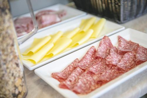 a bunch of different types of meats and cheese at Hotel del Falco in Cervia