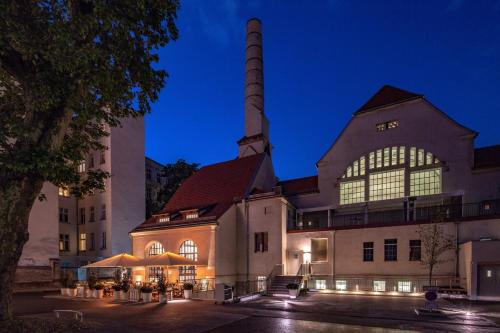 a large building with a tall tower at night at Hotel Oderberger in Berlin