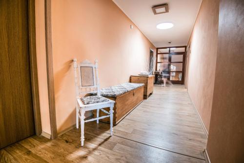 a hallway with a chair in a room at Penzion Hluk in Hluk