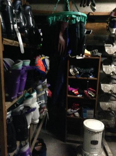 a person standing in front of a closet filled with shoes at Kadowakikan in Nozawa Onsen