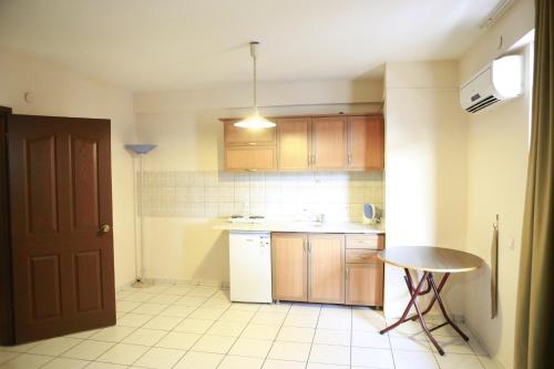 a kitchen with a table and a counter top at Maren Beach Apart Hotel in Alanya