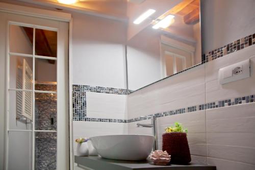 a bathroom with a sink and a mirror at Florence Tower Apartment in Florence