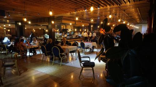 a restaurant with tables and people sitting at tables at Meka Hotel in Dragash