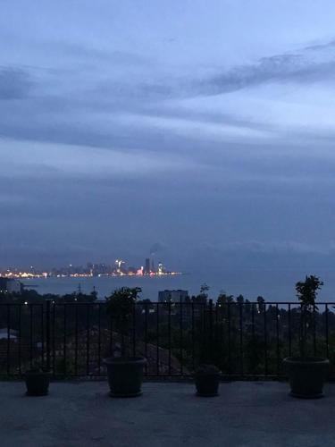 a view of the ocean at night with a fence at 15 Kviparosi Guest House in Makhinjauri