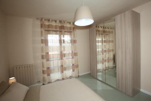 a bedroom with a bed and a large mirror at Residence "Canta" in Pescara