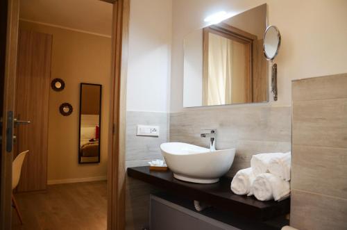 La salle de bains est pourvue d'un lavabo et d'un miroir sur un comptoir. dans l'établissement B&B Al borgo, à Frascati