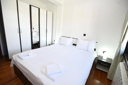 a bedroom with a large white bed with white pillows at Villa Lollobrigida in Ohrid