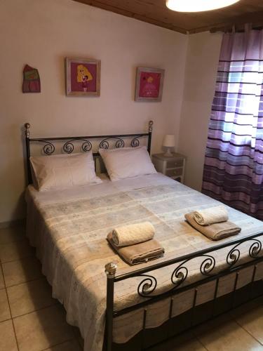 a bedroom with a large bed with two towels on it at Anni House in Stavros in Stavros