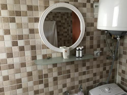 a bathroom with a mirror and a sink and a toilet at Anni House in Stavros in Stavros