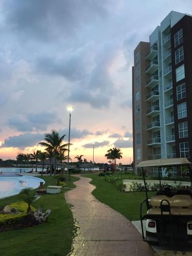 a resort with a golf cart parked next to a building at Departamento en Dream Lagoons Cancun in Cancún