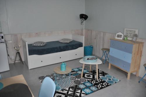 a bedroom with a bed and a table and chairs at Le studio d'Ahynoa in Lauzun