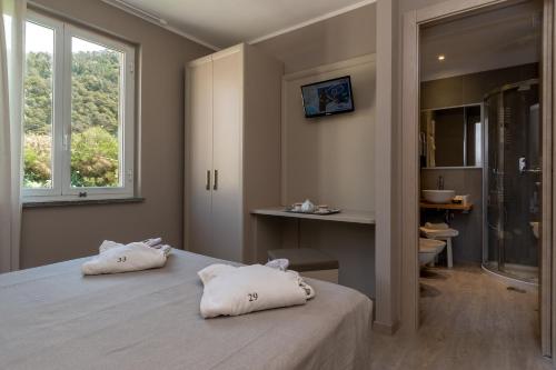 ein Schlafzimmer mit einem Bett mit zwei Kissen darauf in der Unterkunft Hotel 4 Venti spa & wellness in Sestri Levante