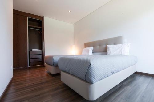 Un ou plusieurs lits dans un hébergement de l'établissement Premium apart - Praia do Furadouro