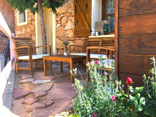 a patio with a table and chairs and flowers at Casa Boracay in Los Pastores