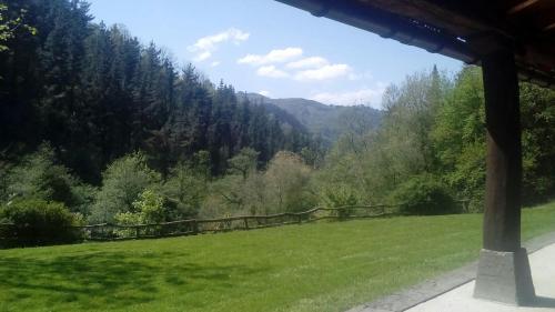 a view of a grassy field with mountains in the background at Casa Rural Goikola in Deba