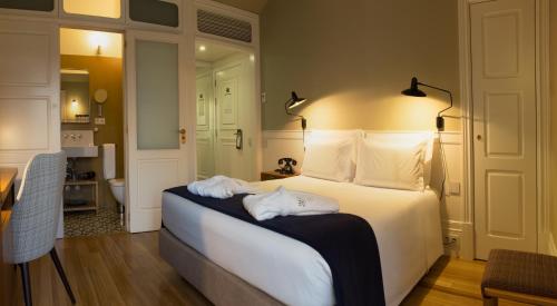 Un ou plusieurs lits dans un hébergement de l'établissement Porto A.S. 1829 Hotel