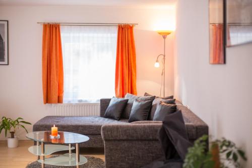 a living room with a couch and a table at Apart Hofer in Nauders