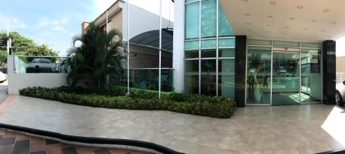a building with a snake in front of it at Hotel Genova Prado in Barranquilla