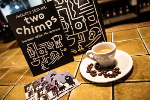 a book and a cup of coffee and a plate of coffee beans at Wisteria Hotel in Oakham