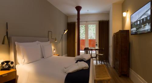 Tempat tidur dalam kamar di Porto A.S. 1829 Hotel