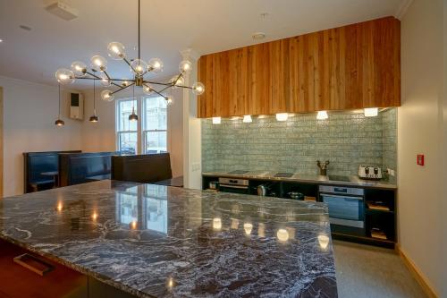 a kitchen with a marble counter top in a room at The Marion Hostel in Wellington