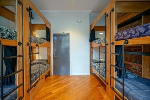 a room with bunk beds and a hallway at The Marion Hostel in Wellington