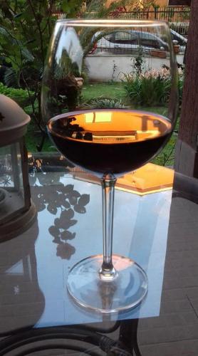 a glass of wine sitting on top of a table at Le Anfore in Marino