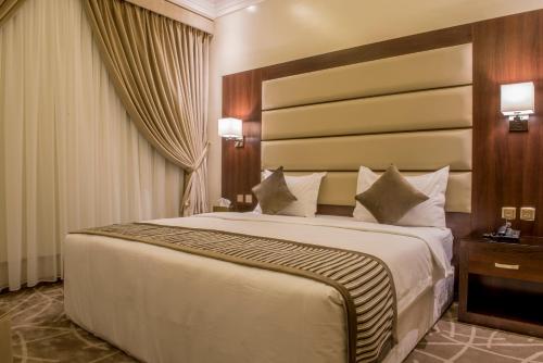 a bedroom with a large bed in a room at نورمينا الشرق للشقق المخدومة in Dammam