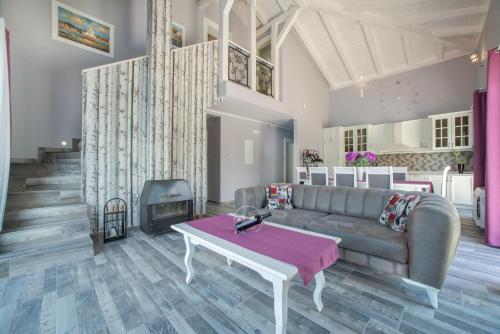 a living room with a couch and a table at StOliva RESIDENCE with infinity pool in Kotor