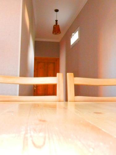 an empty room with a wooden floor and a table at guest house katia tbilisi in Tbilisi City