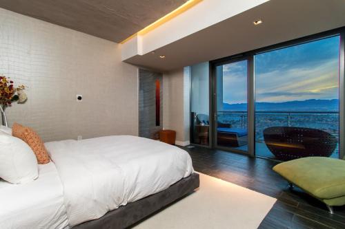 a bedroom with a white bed and a large window at Romance Phenthouse at Palms Place in Las Vegas