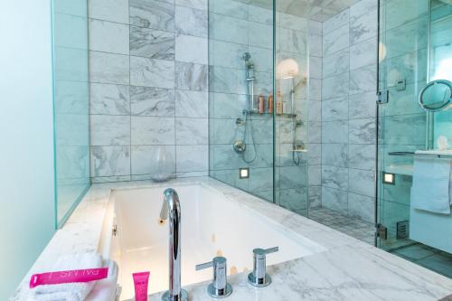 a bathroom with a tub and a shower at Romance Phenthouse at Palms Place in Las Vegas