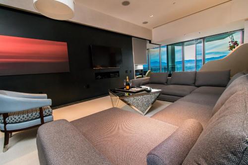 a living room with a couch and a tv at Romance Phenthouse at Palms Place in Las Vegas