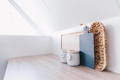 a room with two buckets on the floor next to a wall at Boat house in Hósvik in Hósvík