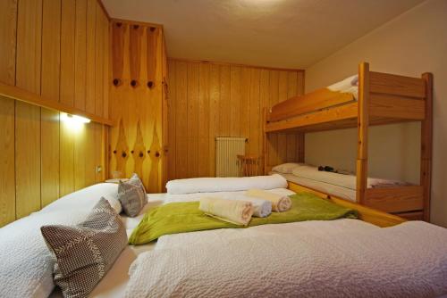 a bedroom with two beds and a bunk bed at Piz da Cir in Colfosco