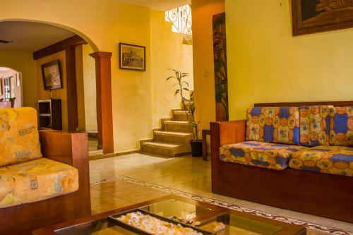 a living room with two couches and a table at Casa De Los Pájaros - B&B in Valladolid