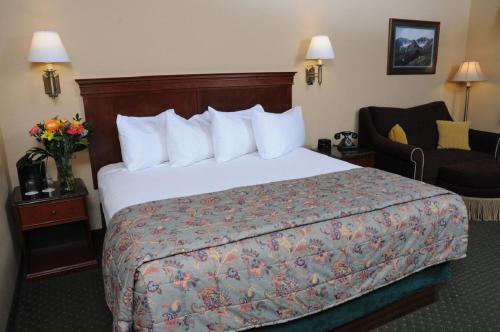 a hotel room with a bed and a chair at Pike's Waterfront Lodge in Fairbanks
